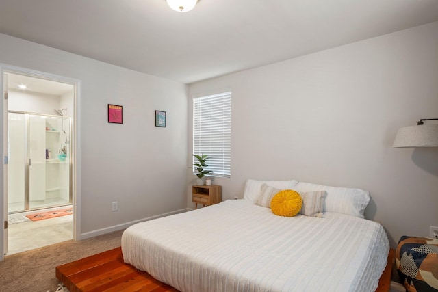 bedroom with baseboards, carpet floors, and ensuite bathroom