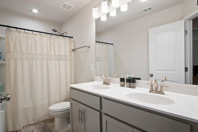 bathroom with a sink, visible vents, and toilet