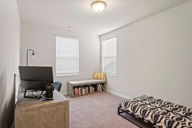 carpeted bedroom featuring baseboards and visible vents