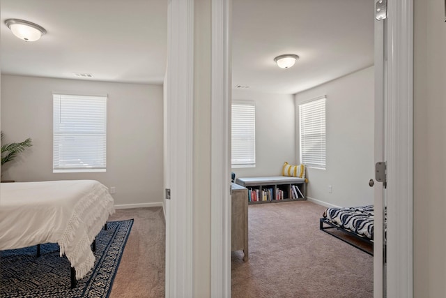 bedroom with visible vents, baseboards, and carpet