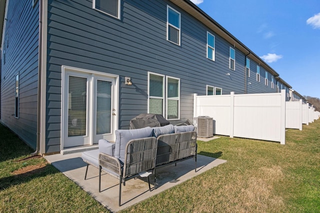 back of house featuring a patio, fence, a yard, cooling unit, and an outdoor hangout area