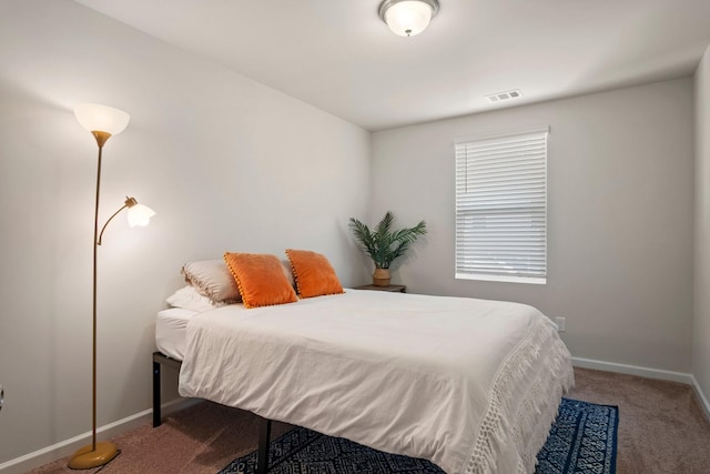 carpeted bedroom with visible vents and baseboards