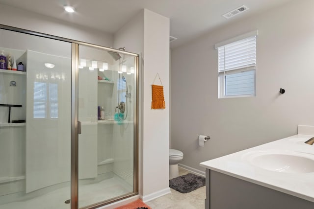 bathroom featuring visible vents, double vanity, a sink, a shower stall, and toilet