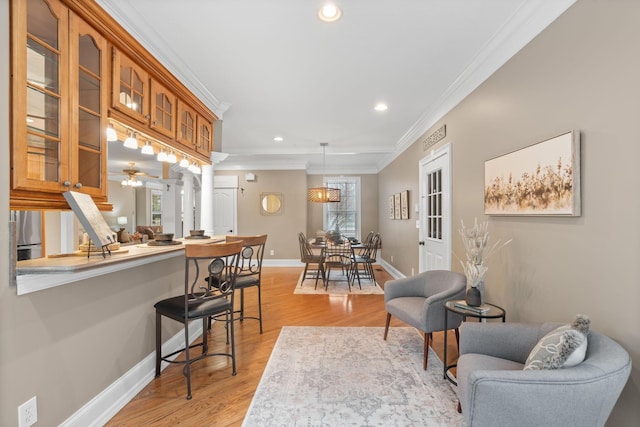 kitchen featuring brown cabinetry, a kitchen breakfast bar, glass insert cabinets, and ornamental molding