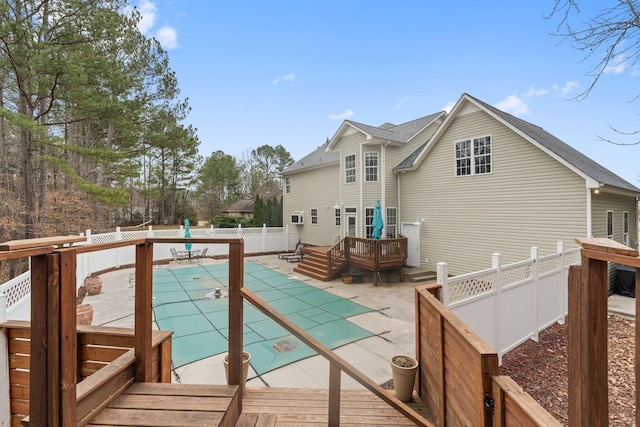 view of pool featuring a fenced in pool, a wooden deck, a fenced backyard, and a patio area