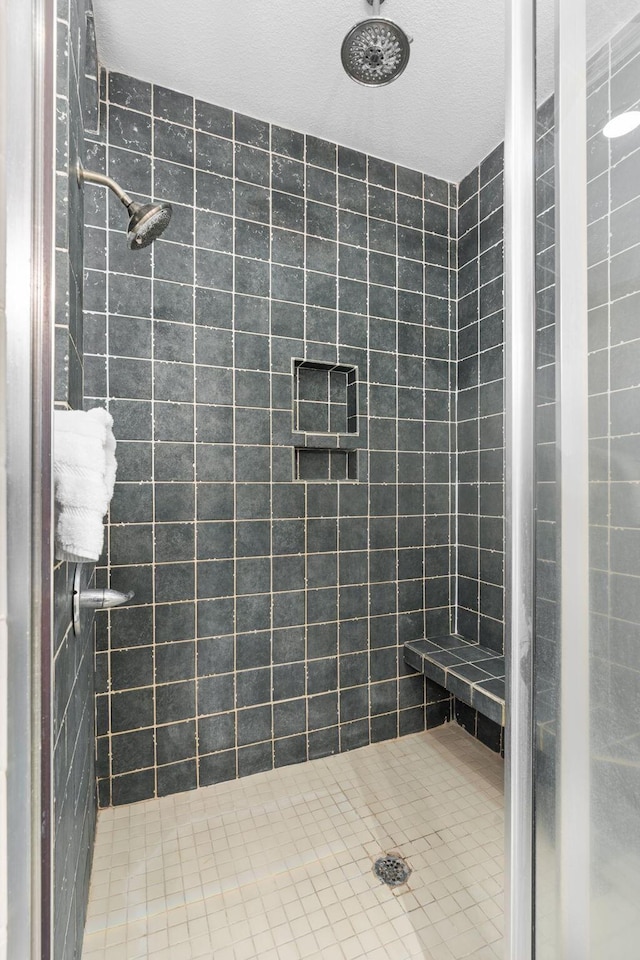 full bath featuring a tile shower