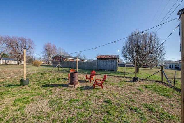 view of yard with an outdoor structure and fence