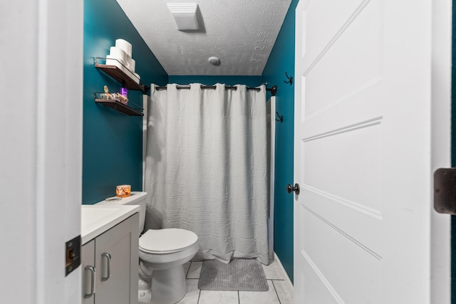 full bathroom featuring toilet, curtained shower, a textured ceiling, tile patterned flooring, and vanity