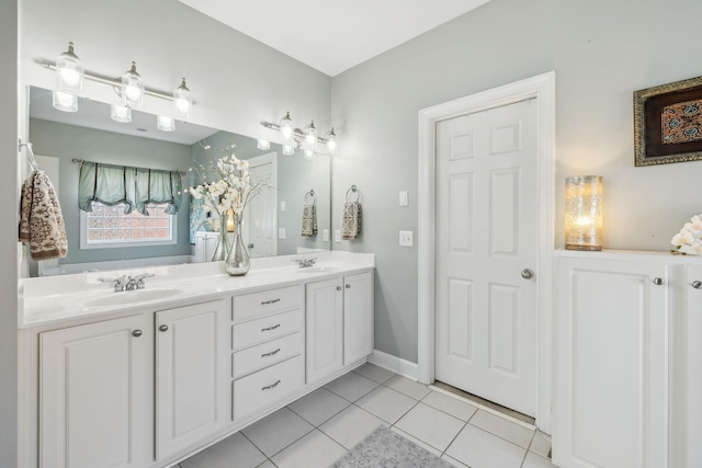 full bathroom with tile patterned flooring, double vanity, and a sink