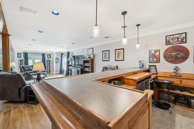 bar with ornamental molding, recessed lighting, light tile patterned floors, bar area, and hanging light fixtures