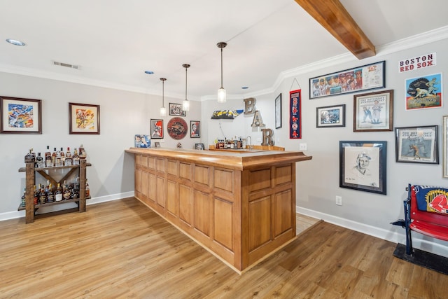 bar featuring wet bar, light wood-style floors, visible vents, and ornamental molding