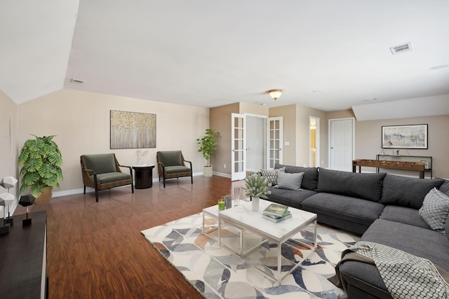 living room with visible vents, baseboards, and wood finished floors