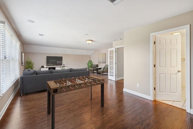 living room featuring visible vents, baseboards, and dark wood-type flooring