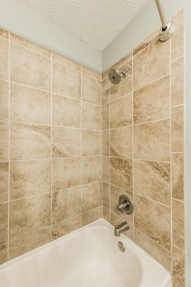 full bath featuring shower / washtub combination and a textured ceiling