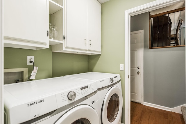 washroom with cabinet space, dark wood-style floors, independent washer and dryer, and baseboards