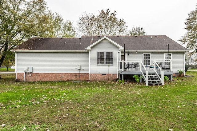 rear view of house featuring crawl space, a yard, and a wooden deck