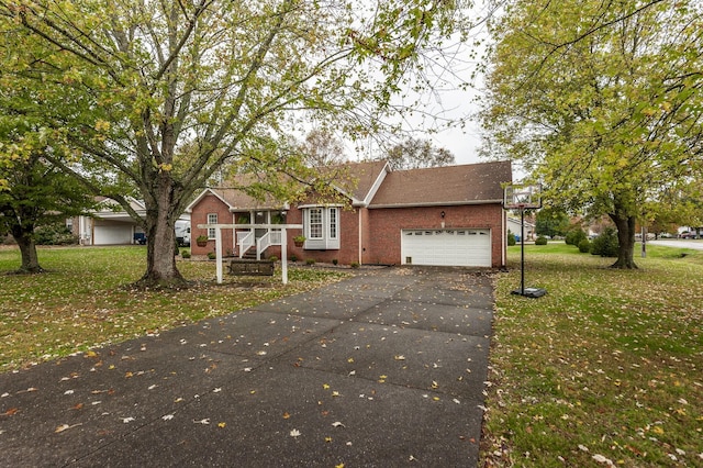 view of front of property featuring brick siding, a garage, driveway, and a front yard