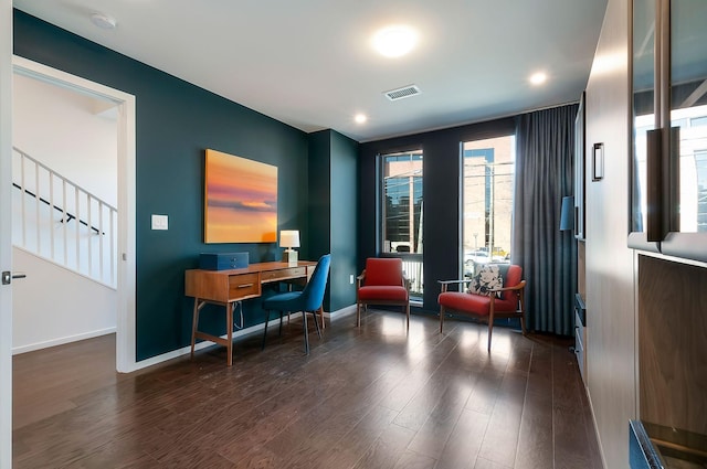 office space with visible vents, baseboards, and dark wood-style floors