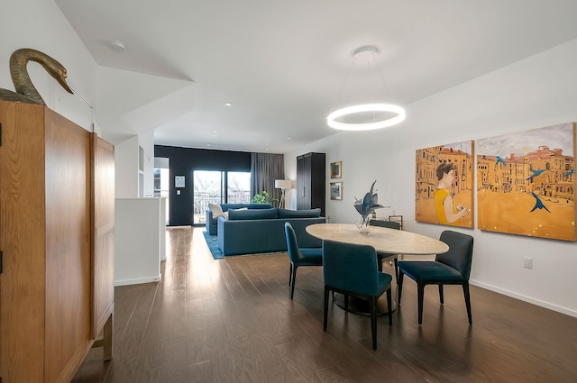 dining room featuring dark wood-type flooring and baseboards