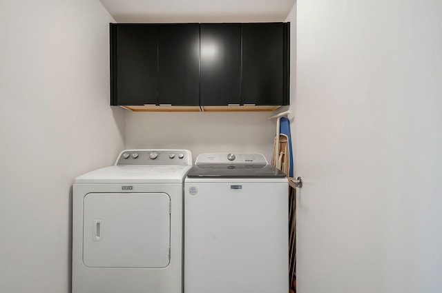 laundry area with cabinet space and washer and clothes dryer