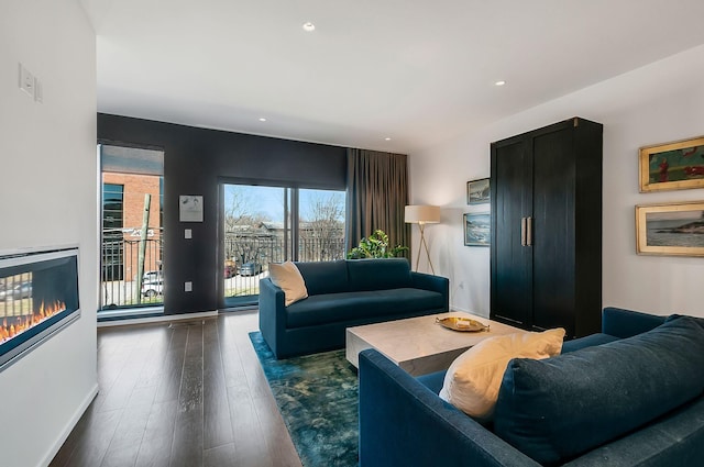 living area with recessed lighting, baseboards, and dark wood-style floors