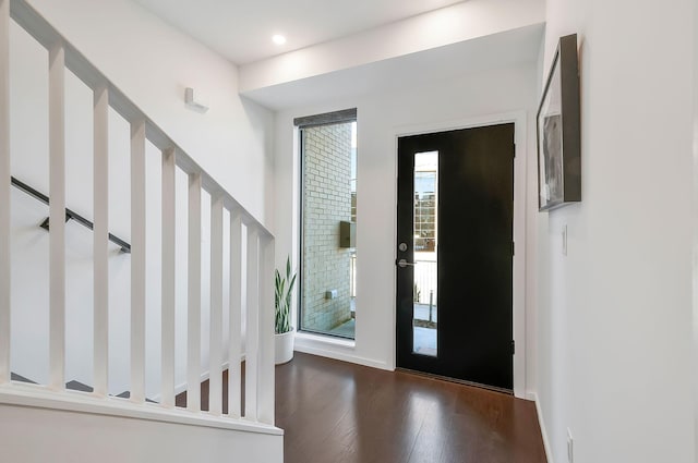 entrance foyer with stairway, recessed lighting, dark wood-style flooring, and baseboards