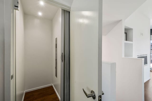 details with stainless steel oven, baseboards, and wood finished floors