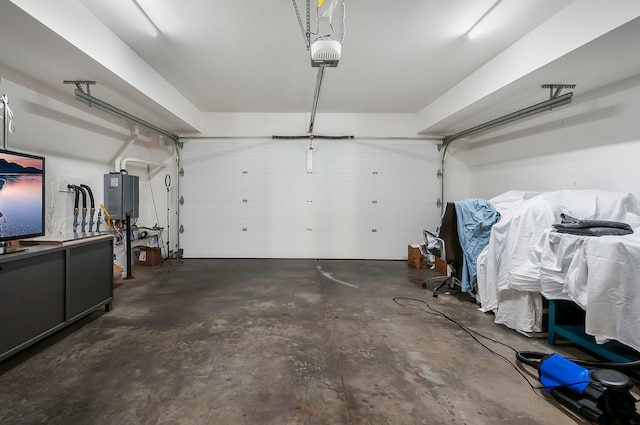 garage featuring a garage door opener and tankless water heater