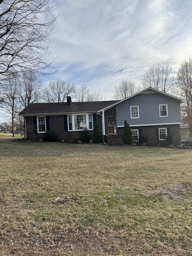 view of front of house featuring a front lawn and a chimney