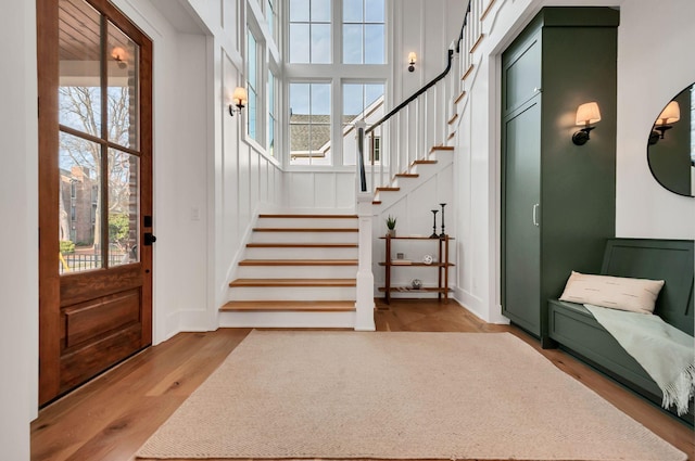 foyer entrance with stairway and wood finished floors