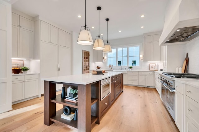 kitchen with custom exhaust hood, tasteful backsplash, light countertops, and open shelves