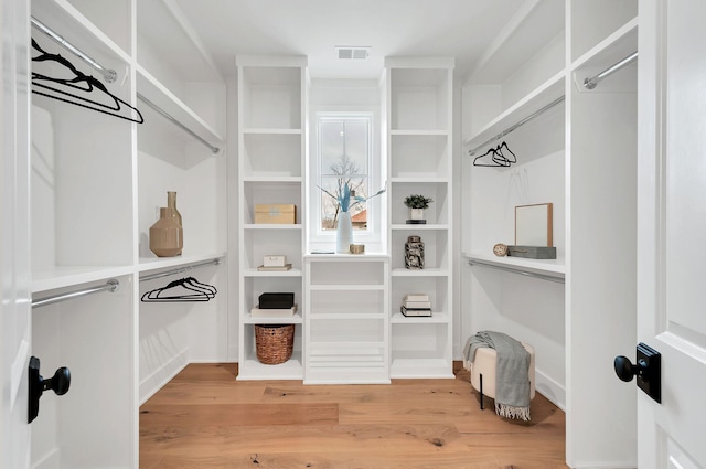 walk in closet with visible vents and wood finished floors