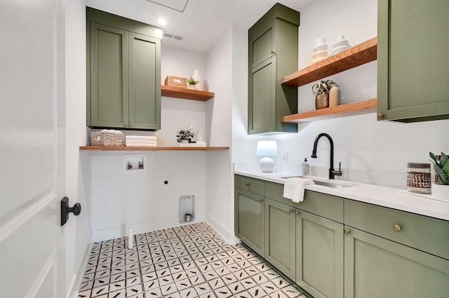 clothes washing area with electric dryer hookup, visible vents, a sink, cabinet space, and hookup for a washing machine