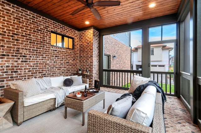 sunroom / solarium with plenty of natural light, wood ceiling, and ceiling fan