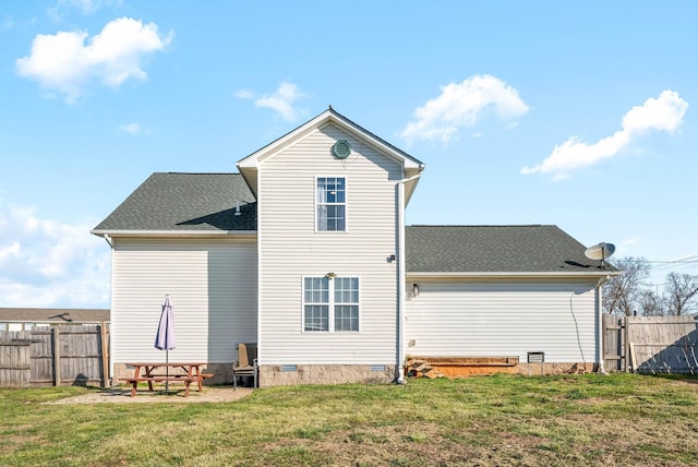 back of house with crawl space, roof with shingles, a yard, and fence