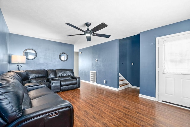 living room featuring visible vents, baseboards, stairway, wood finished floors, and a ceiling fan