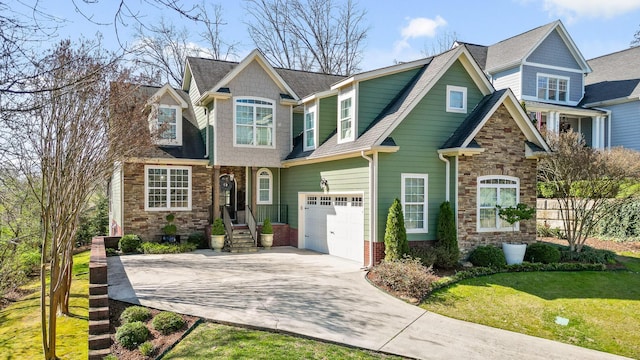 craftsman-style house featuring a front lawn, roof with shingles, concrete driveway, and an attached garage