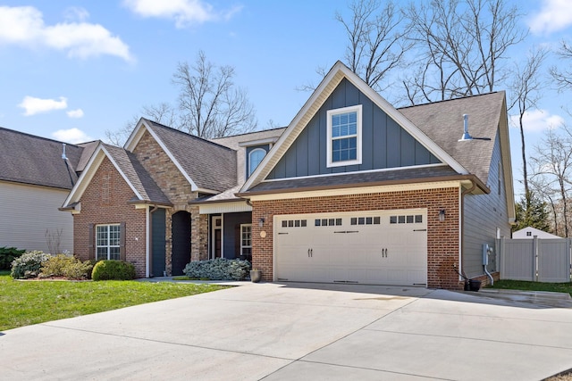 craftsman-style house with brick siding, board and batten siding, fence, driveway, and a gate