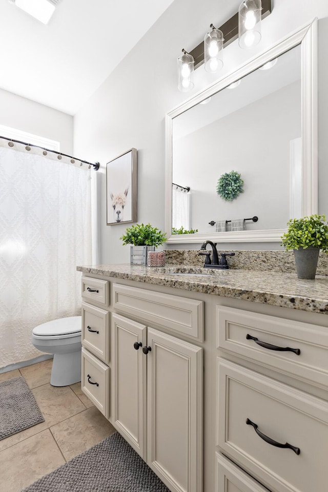 full bath with vanity, toilet, and tile patterned flooring