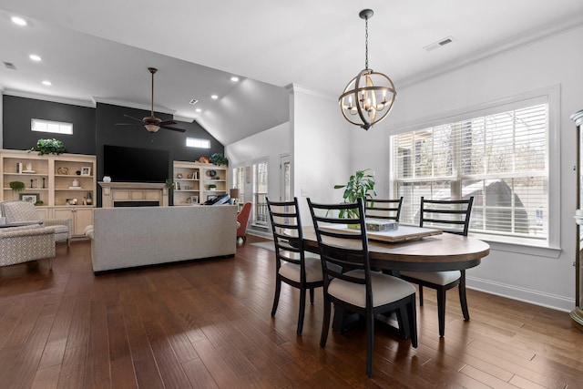 dining space featuring visible vents, dark wood finished floors, crown molding, and ceiling fan with notable chandelier