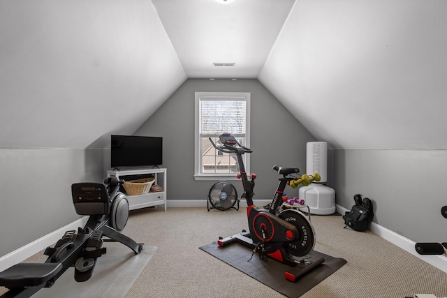 exercise room featuring visible vents, baseboards, carpet, and vaulted ceiling