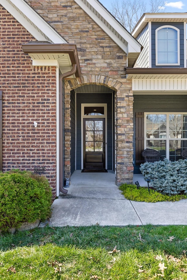 doorway to property with stone siding