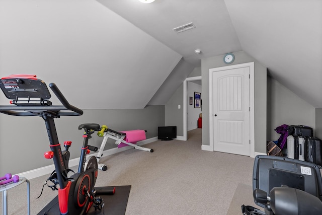 workout room with carpet, lofted ceiling, baseboards, and visible vents