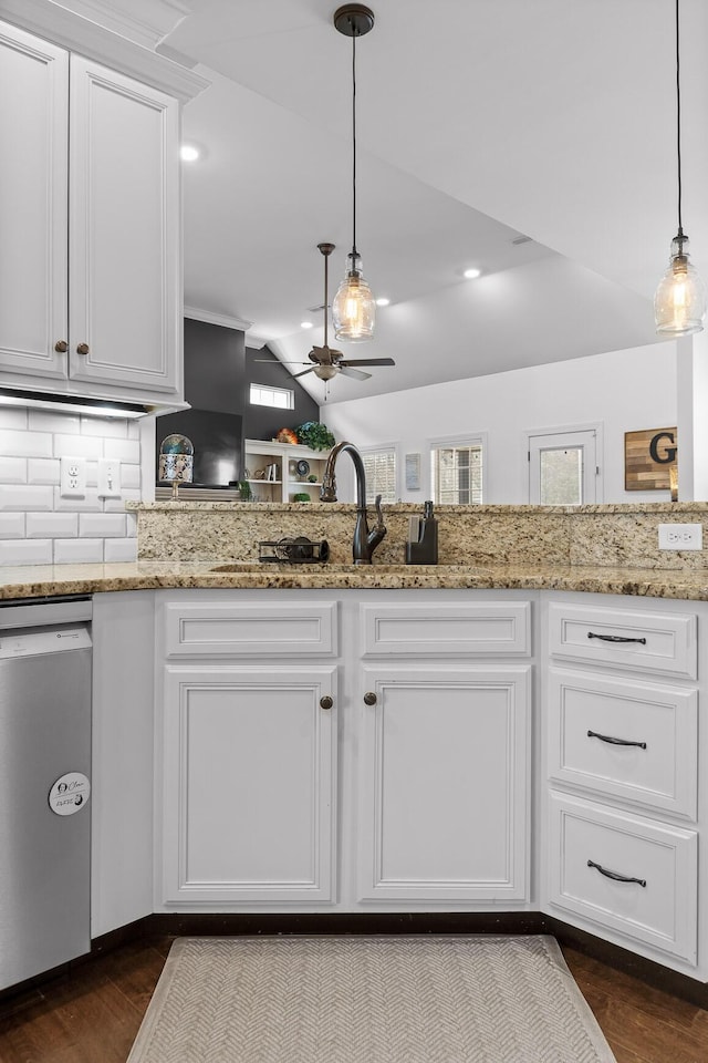 kitchen featuring vaulted ceiling, dark wood-style floors, white cabinetry, a ceiling fan, and stainless steel dishwasher