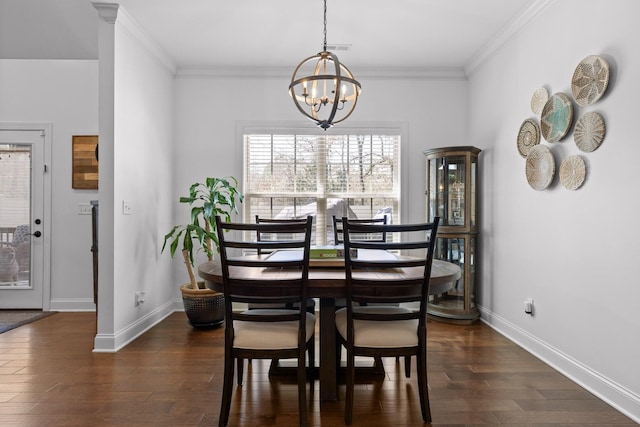 dining area with dark wood-type flooring, a notable chandelier, and crown molding