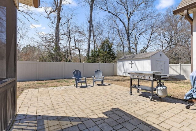 view of patio featuring a fenced backyard, a shed, and an outdoor structure