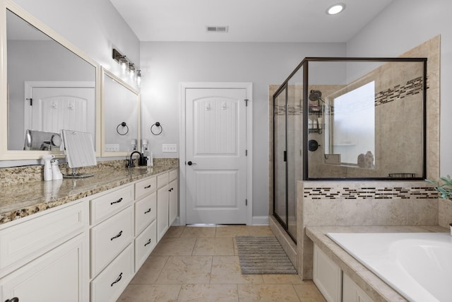 full bathroom featuring visible vents, a garden tub, a stall shower, a sink, and double vanity