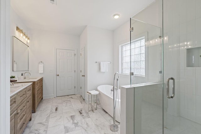 full bathroom featuring a soaking tub, double vanity, a sink, a shower stall, and marble finish floor