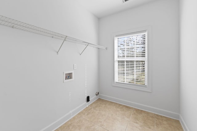 laundry room featuring laundry area, plenty of natural light, baseboards, and washer hookup