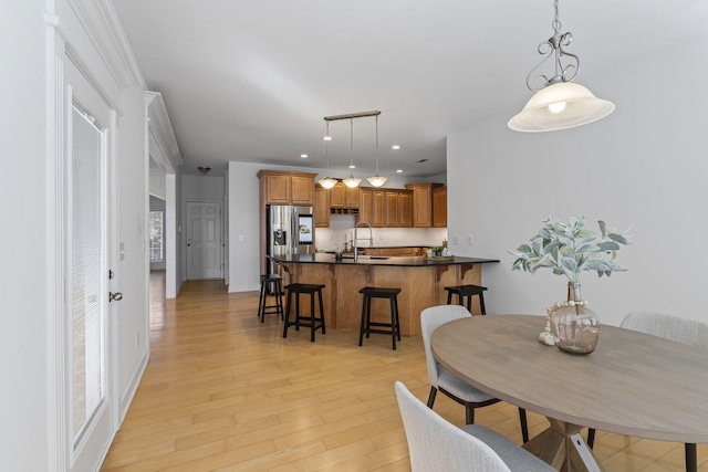 dining room featuring recessed lighting and light wood-style flooring